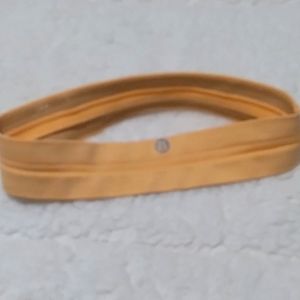 NWOT, LULULEMON headband, lt. orange or peachy